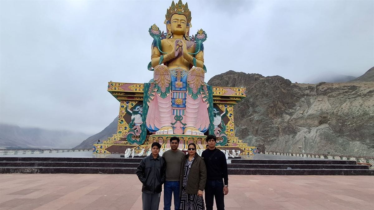 Travellers below a Buddha statue in Ladakh